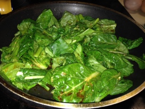 Sauteing Tatsoi in some of the juice from the crock pot.